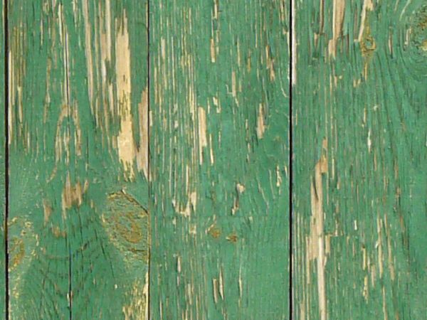Weathered planks set in vertical fashion with scratches and fading paint.